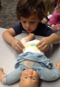 Big Brother Practicing Diaper Change