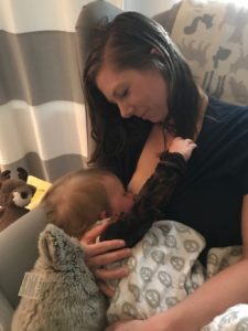 baby breastfeeding with mother