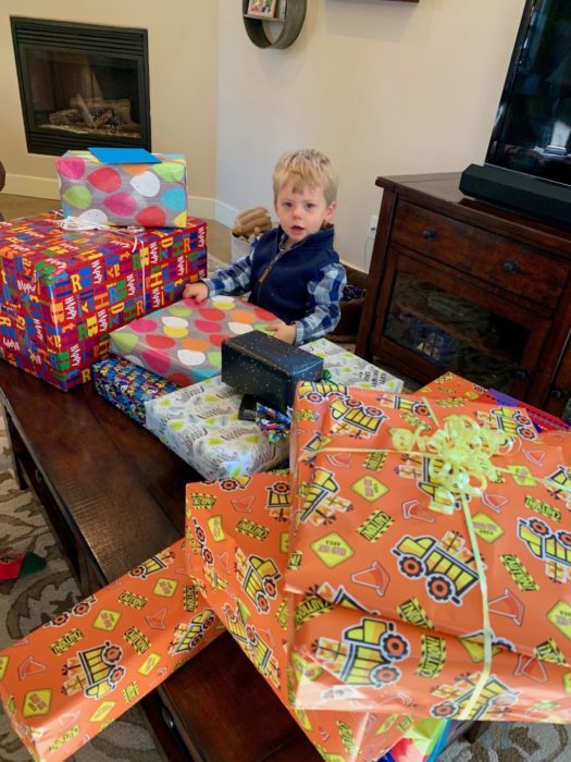 child with birthday gifts