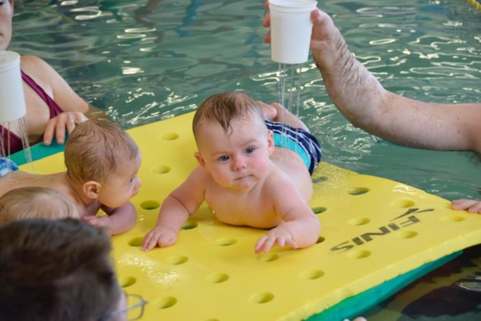 baby floating on mat in water at Emler Swim School in Austin, Texas