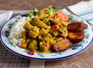 A view of a Caribbean dish of curry chicken in a restaurant or kitchen setting