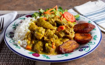 A view of a Caribbean dish of curry chicken in a restaurant or kitchen setting