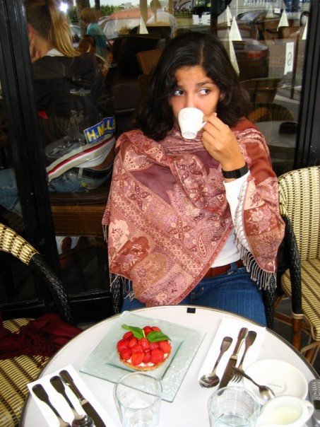 Au Pair Angie sips an espresso and eats a strawberry tarte at one of Paris' sidewalk cafes.