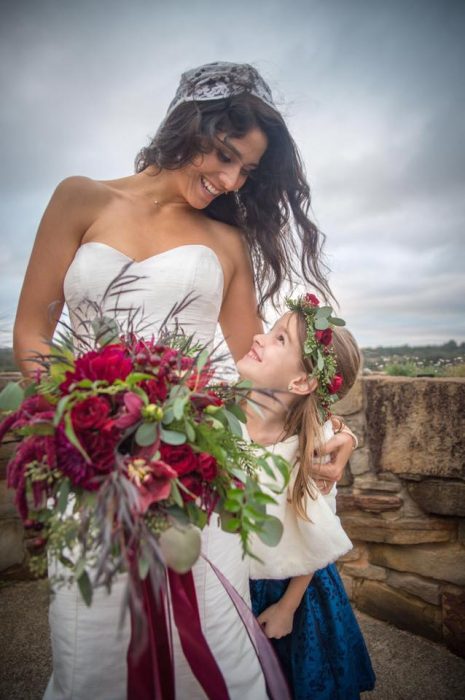 The author on her wedding day with her step daughter. They lovingly look at each other.