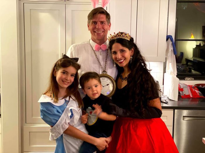 The author and her family pose on Halloween, dressed as characters from Alice in Wonderland.